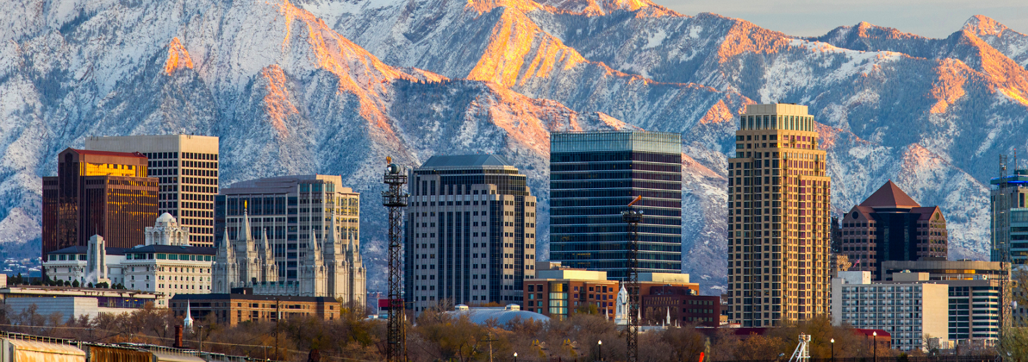 A city with tall buildings and mountains in the background.