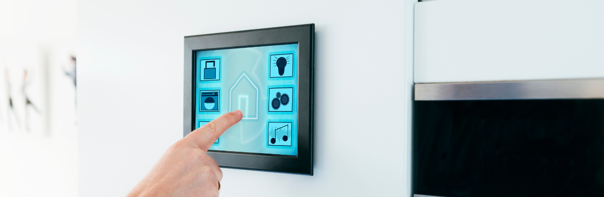 A hand holding a small square object.