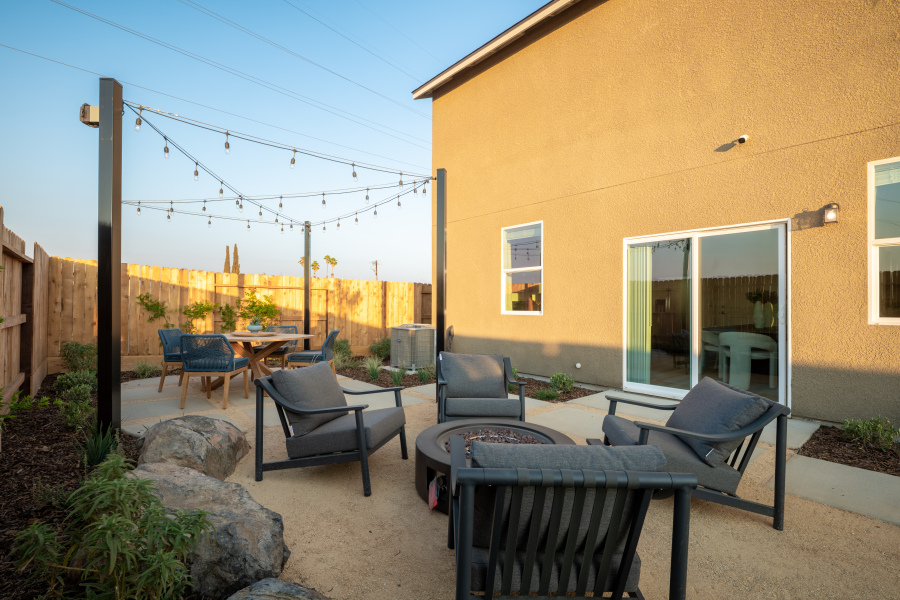 A patio with chairs and tables.