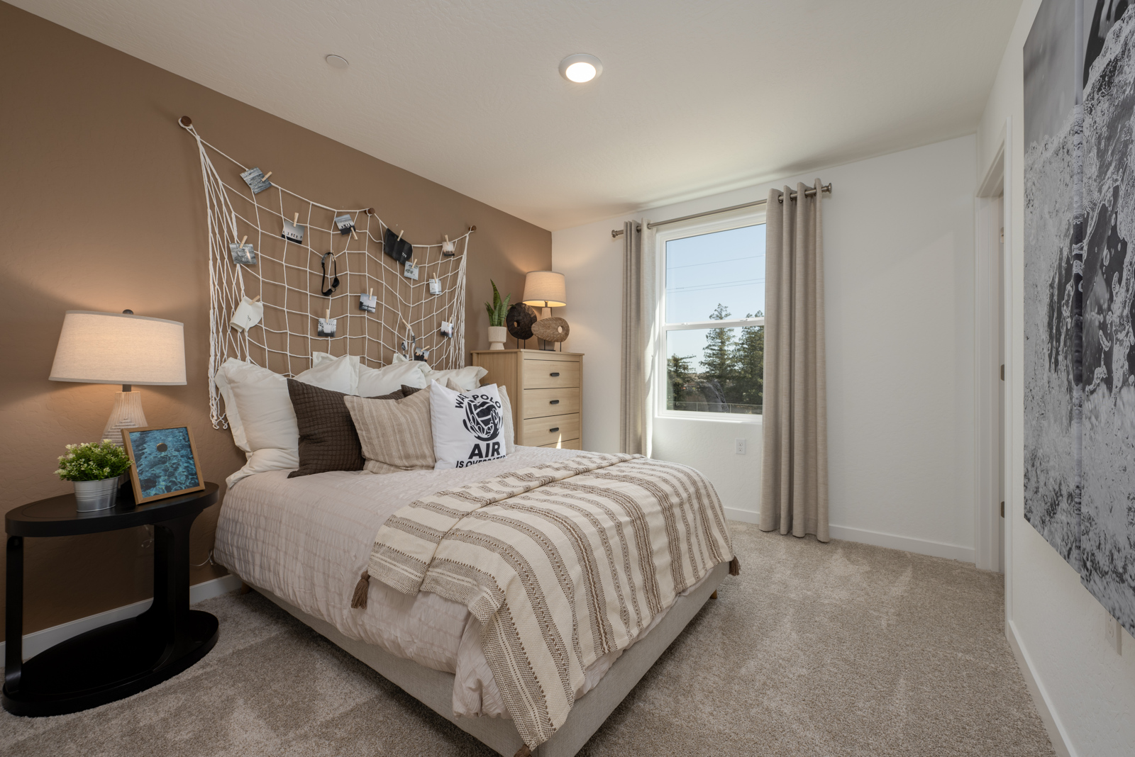 A bedroom with a bed and a table.