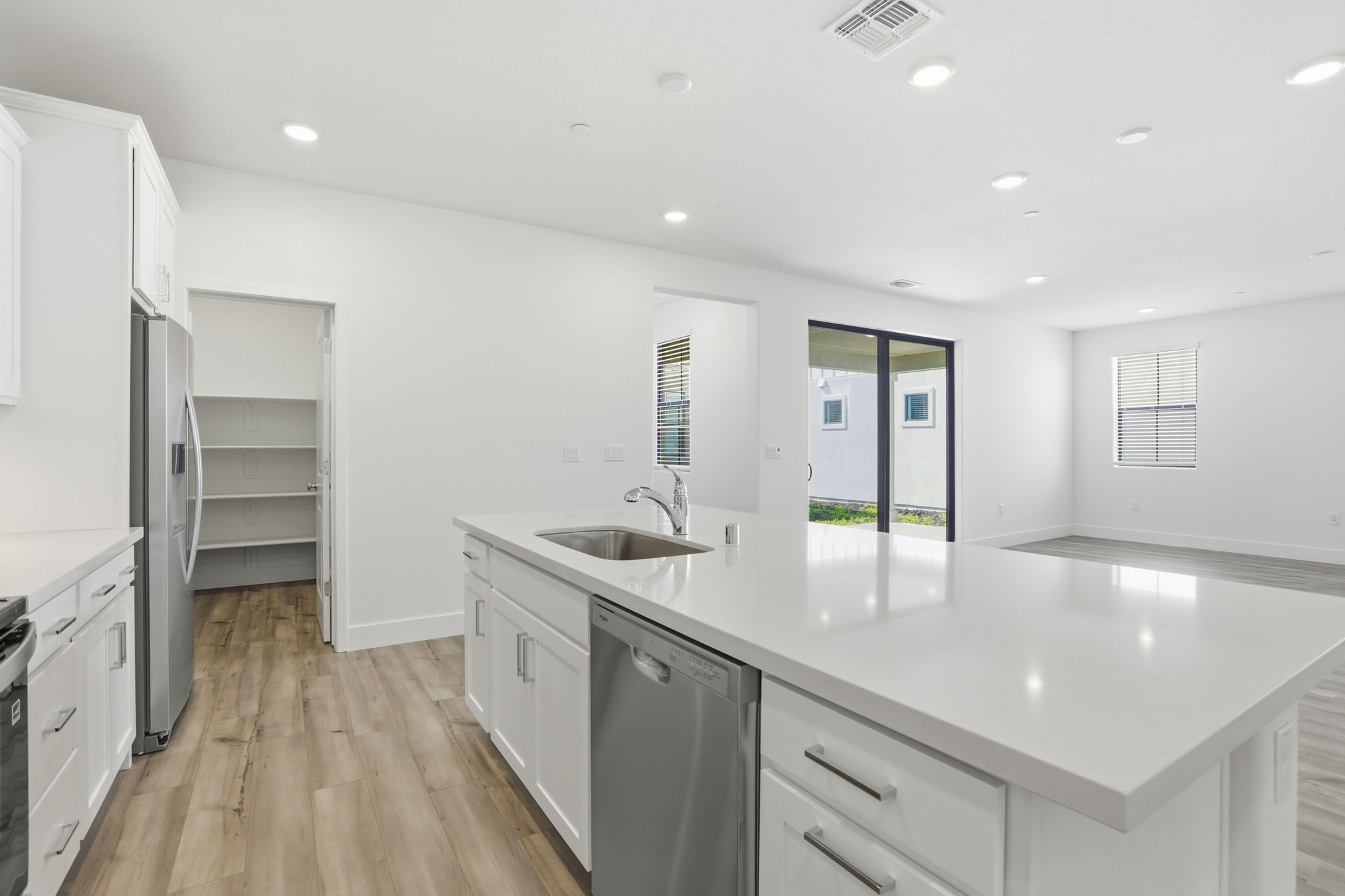 A kitchen with white cabinets.