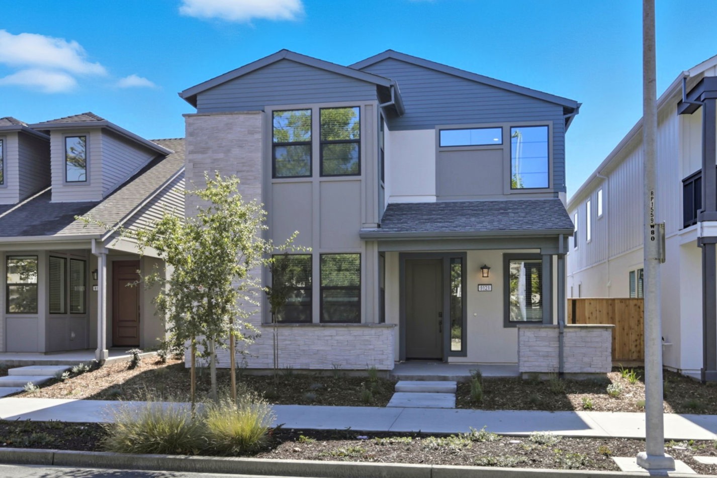 A house with a tree in the front.