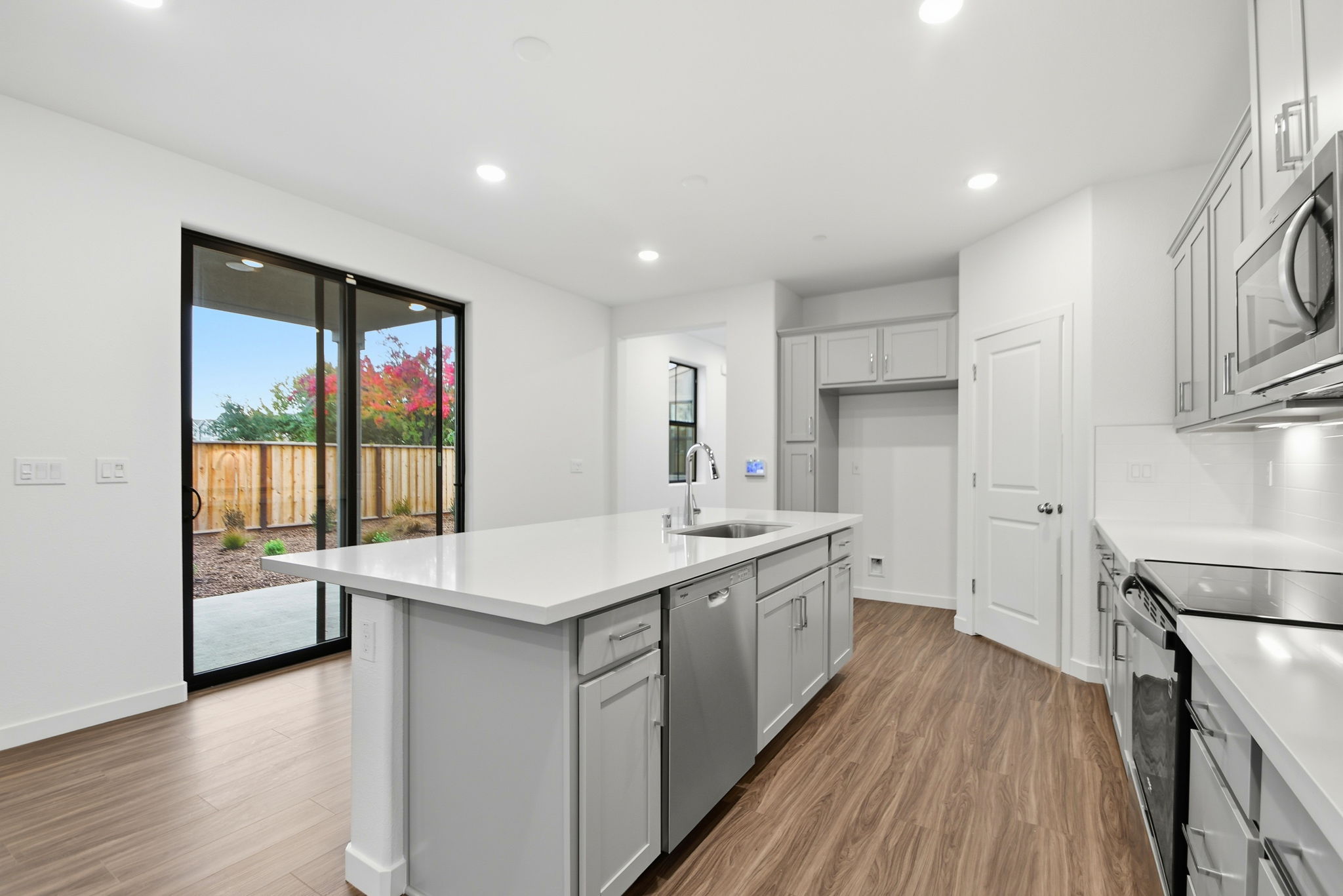 A kitchen with white cabinets.