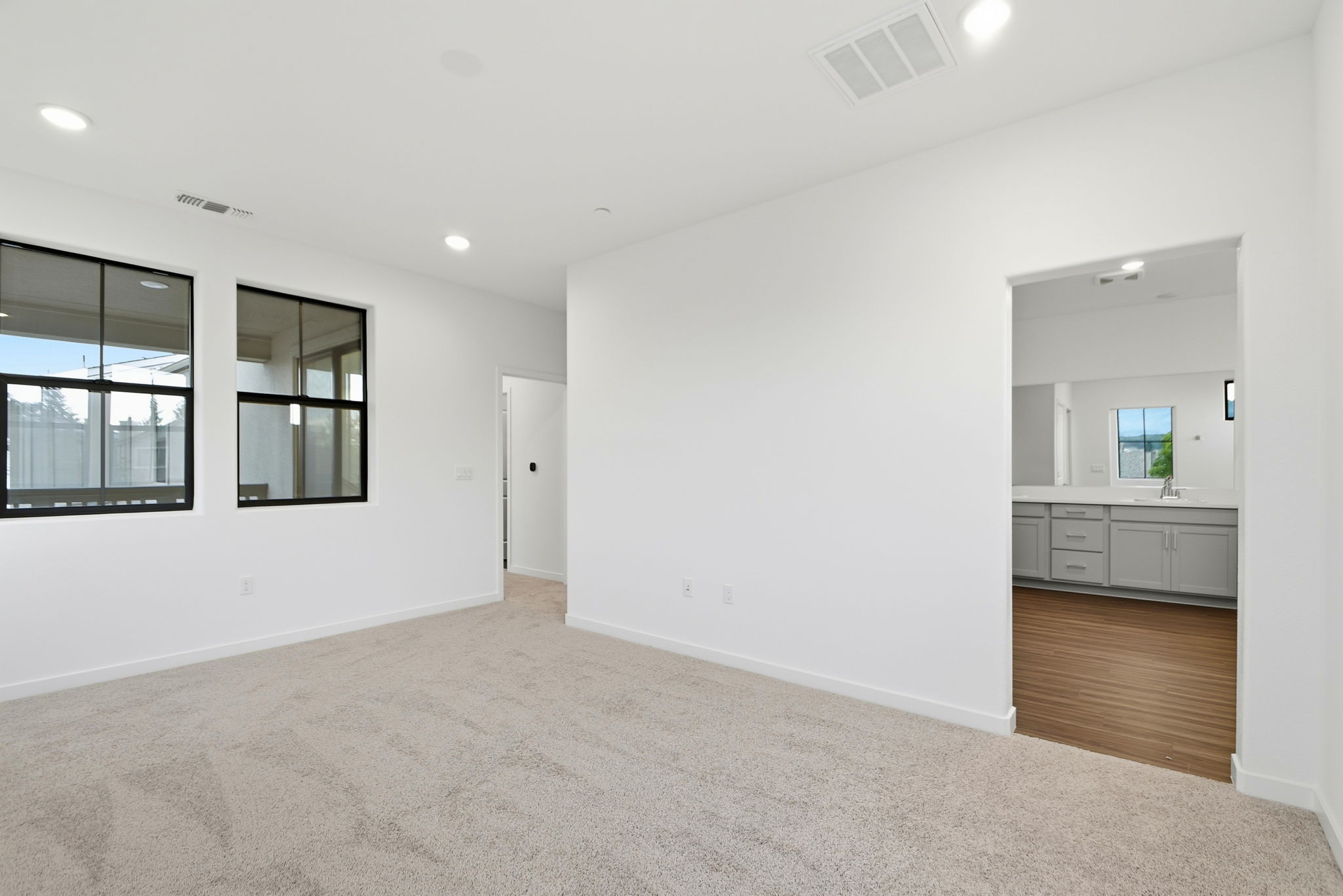 A room with white walls and a carpeted floor.