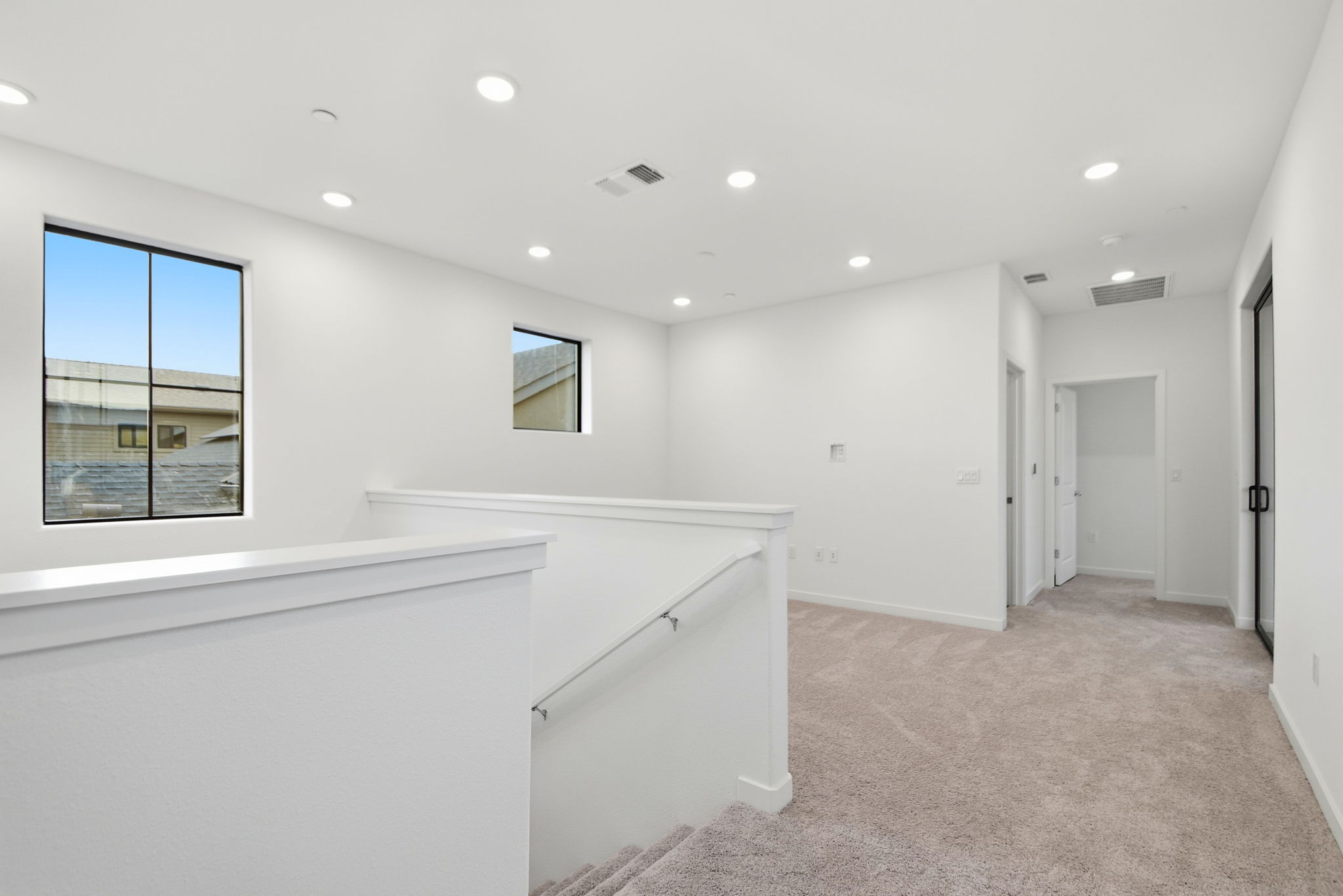 A room with white walls and a window.