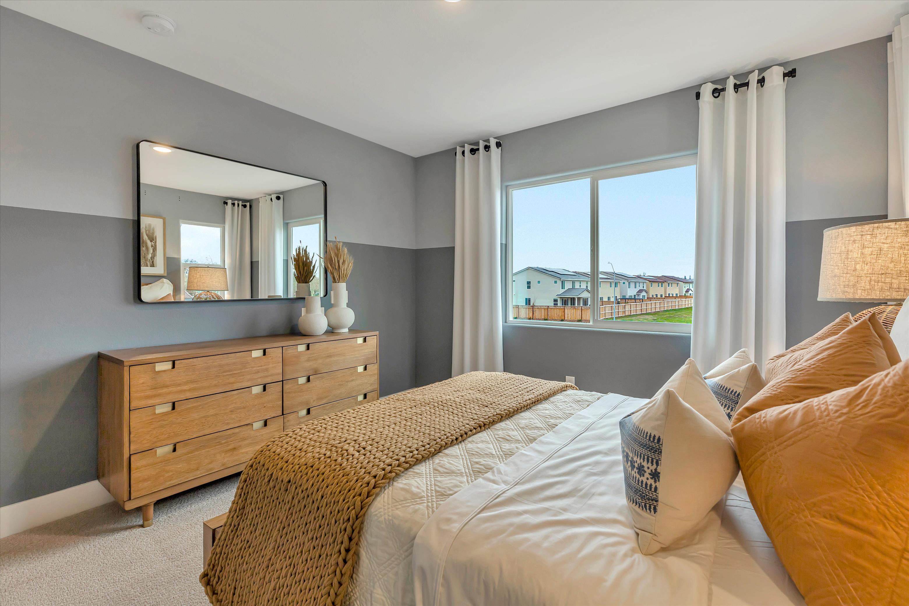 A bedroom with a large window.