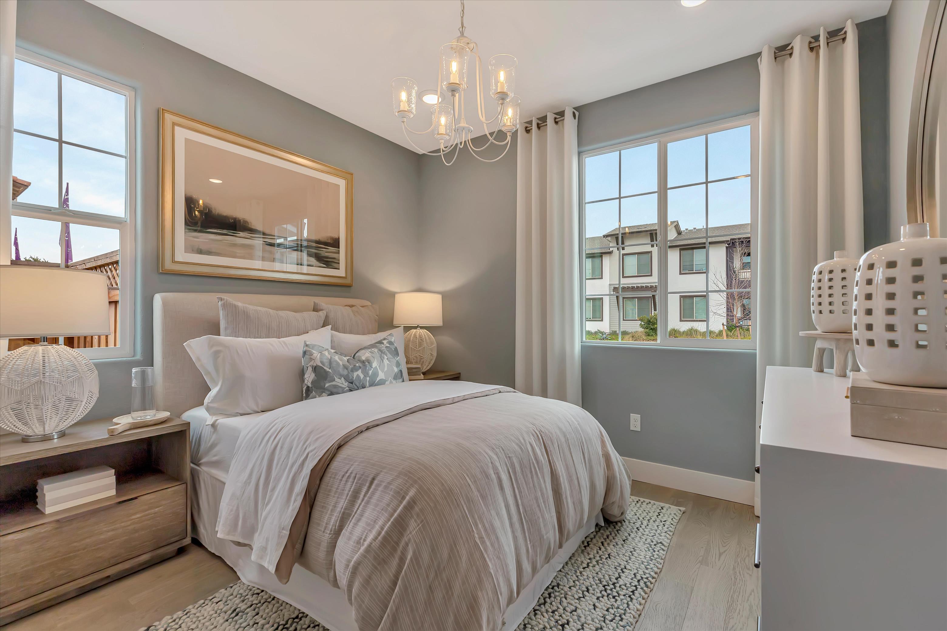 A bedroom with a large window.