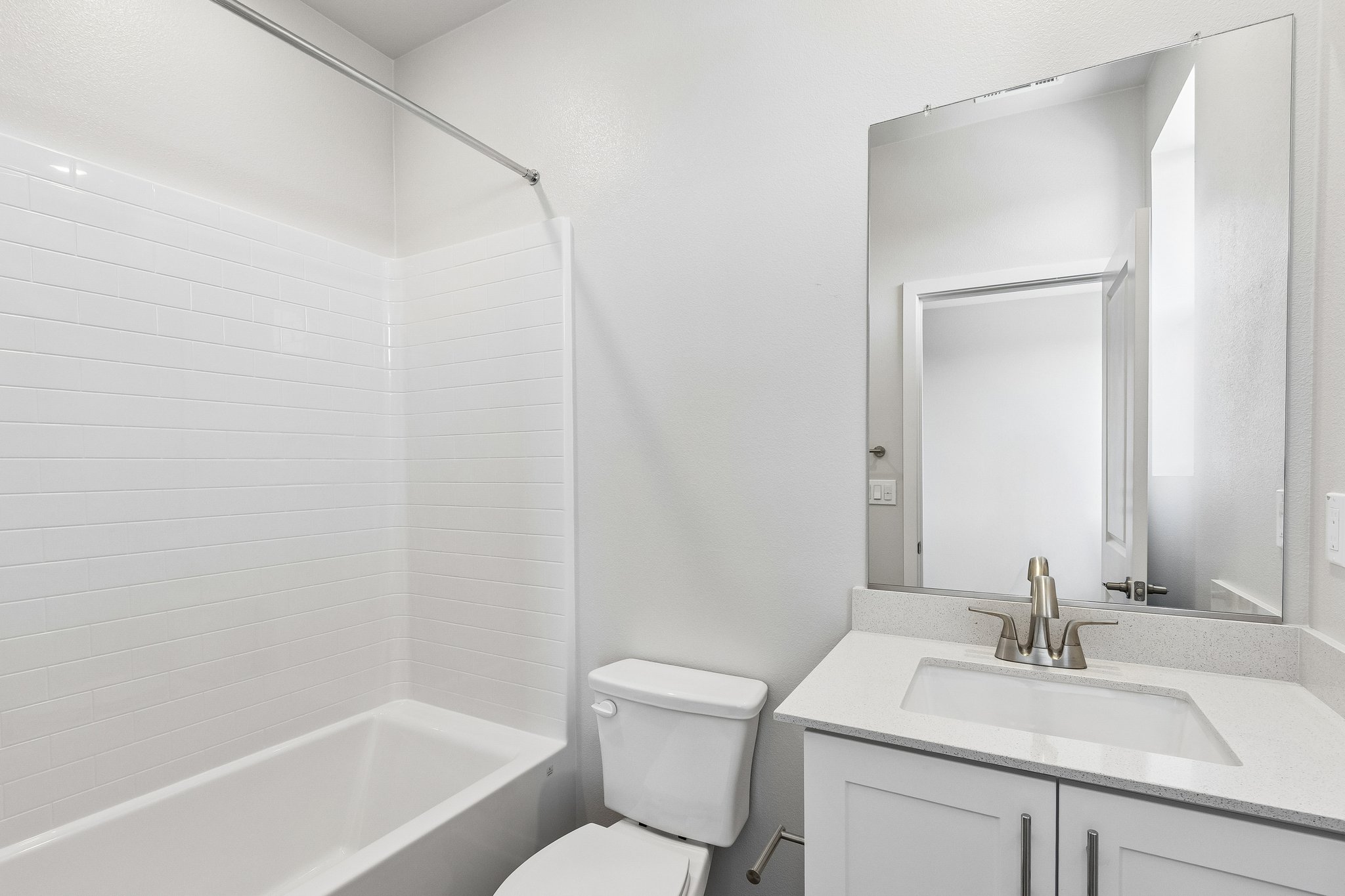 A bathroom with a tub sink and toilet.