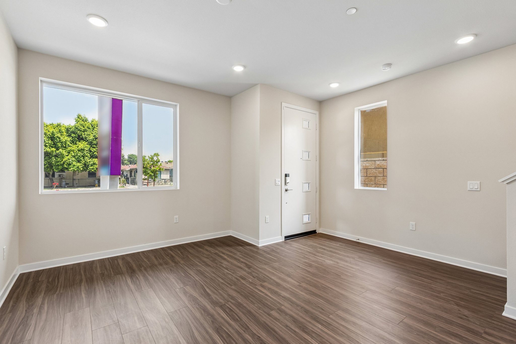 A room with a wood floor and a window with a wood floor.