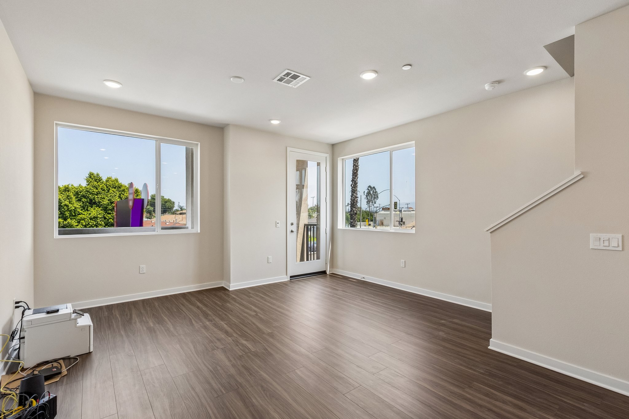 A room with a wood floor and a window.