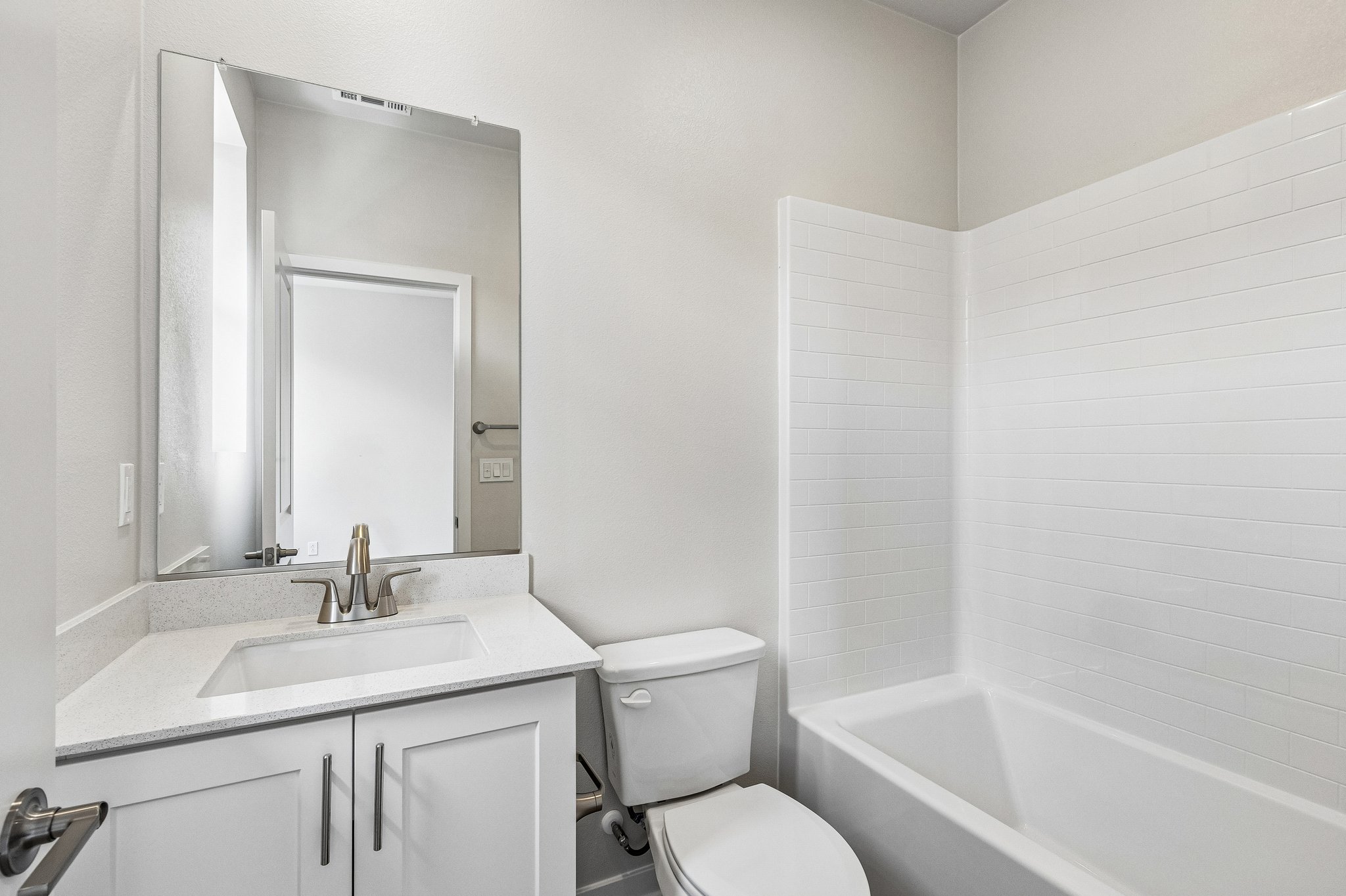 A bathroom with a tub sink and toilet.