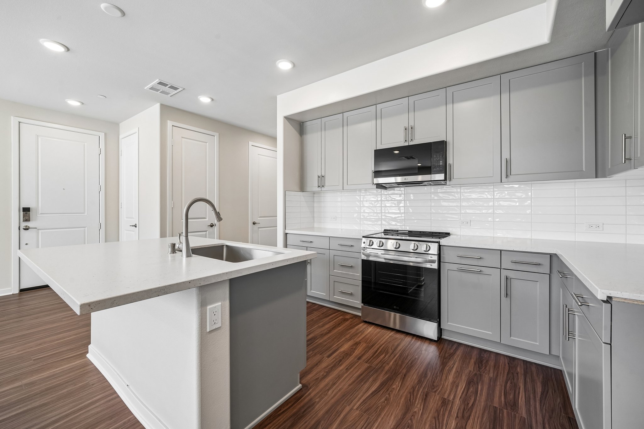 A kitchen with white cabinets.