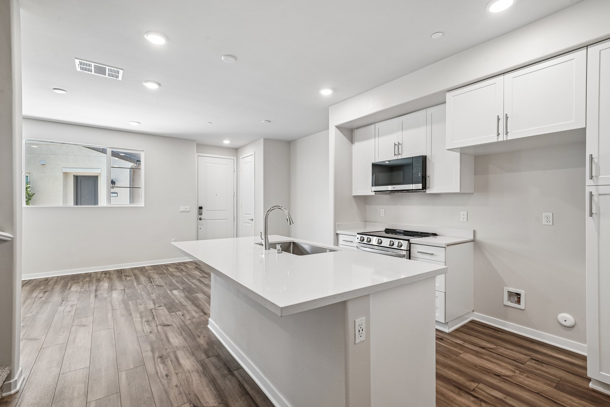 A kitchen with white cabinets.