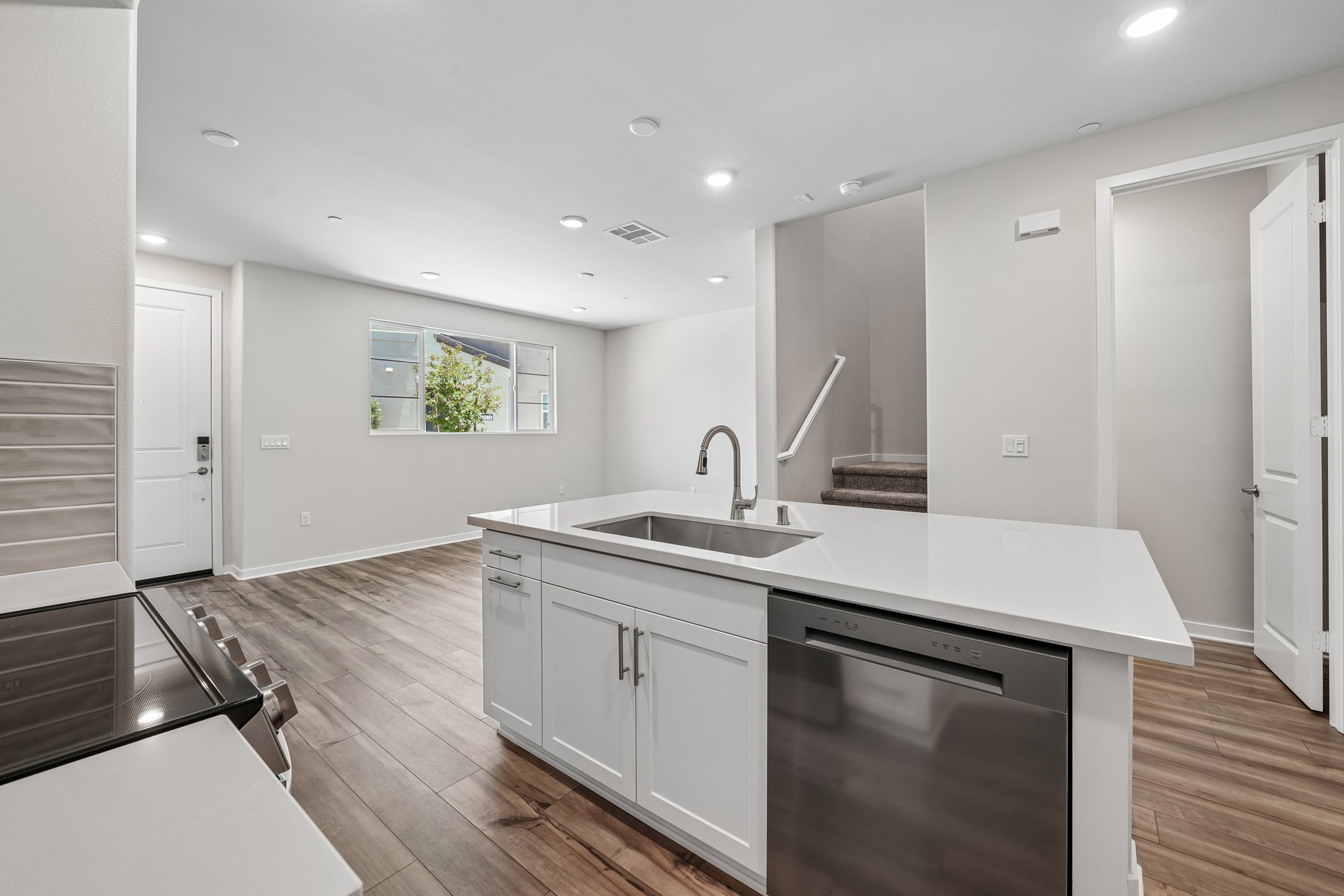 A kitchen with white cabinets.