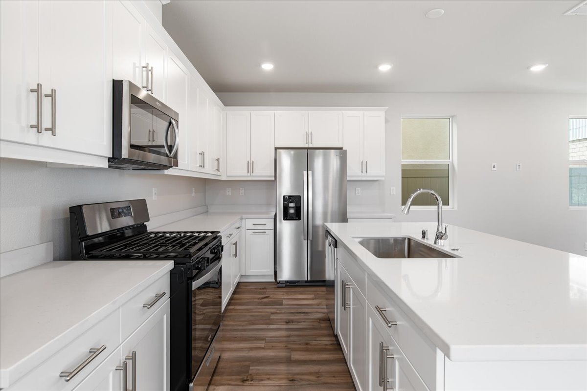 A kitchen with white cabinets.