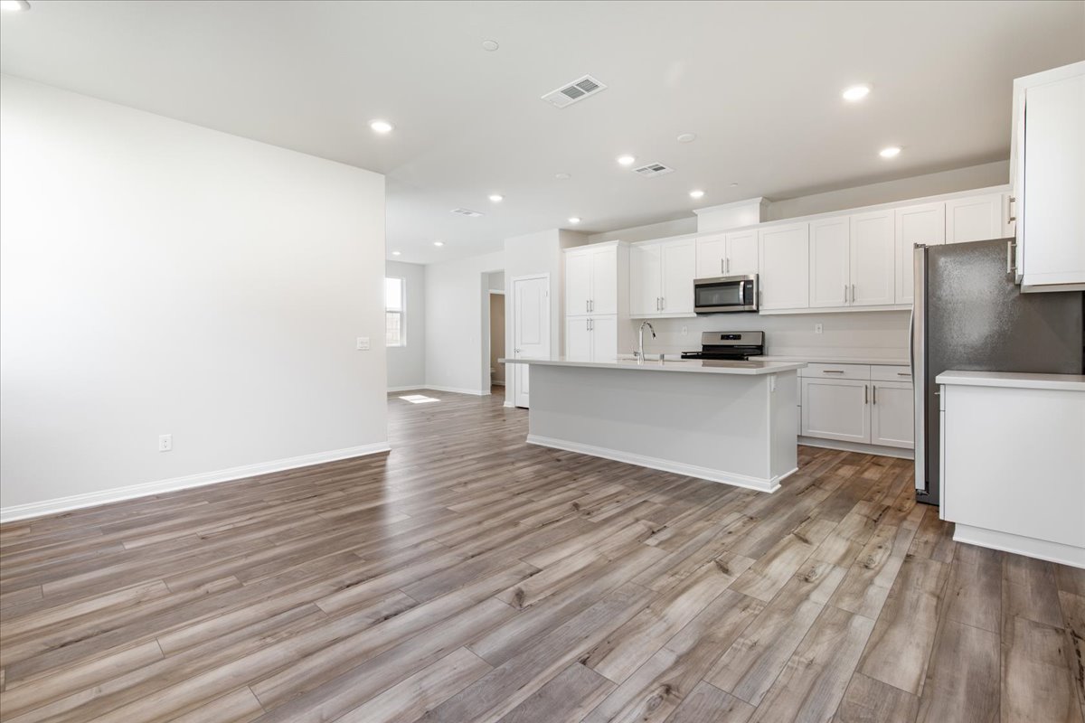 A large kitchen with white cabinets.