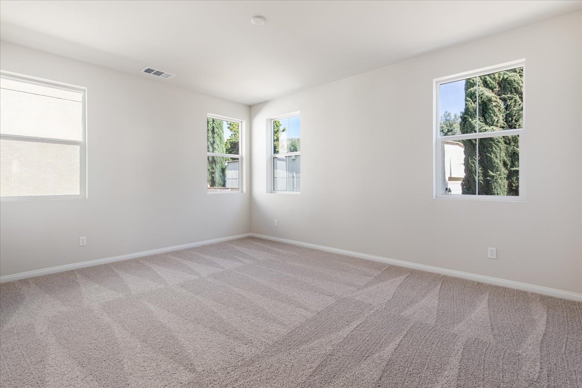 A room with windows and a carpet.