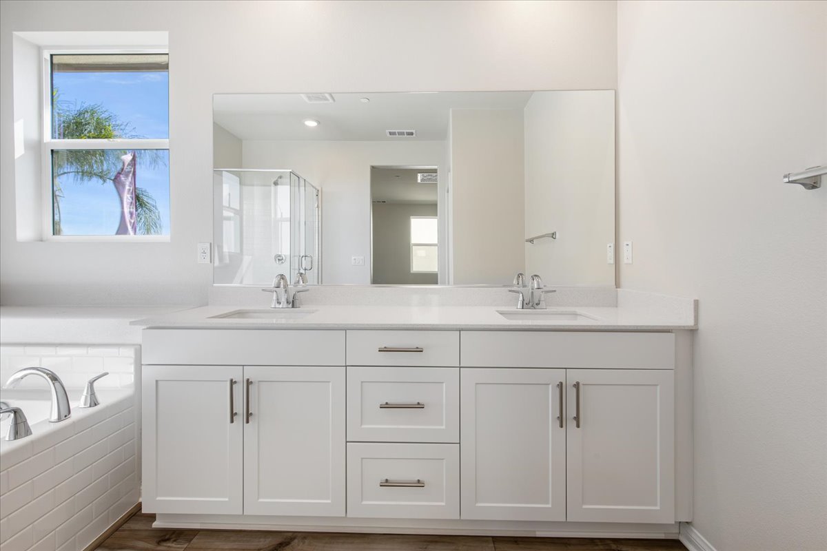 A bathroom with white cabinets.
