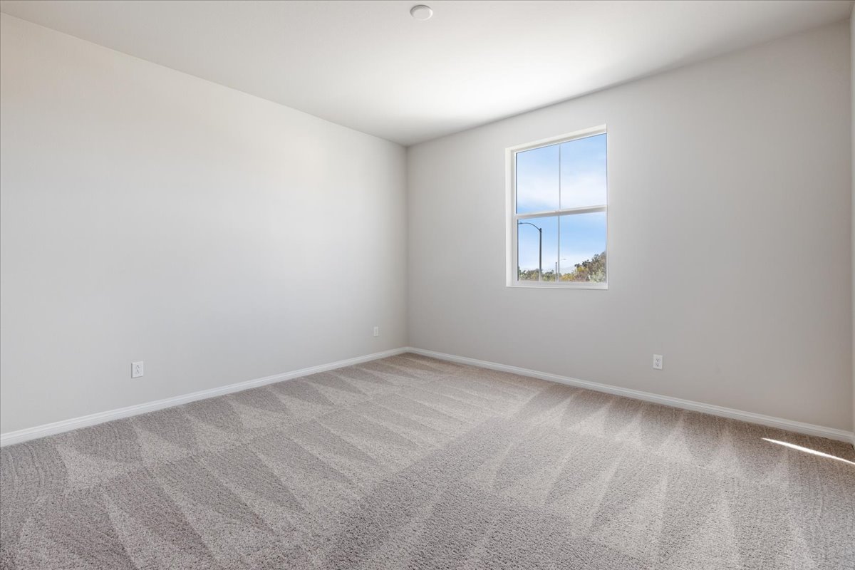 A room with a window and a carpet.