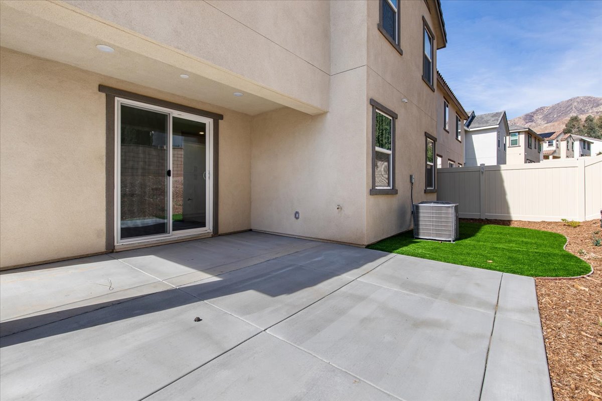 A building with a fence and a lawn.
