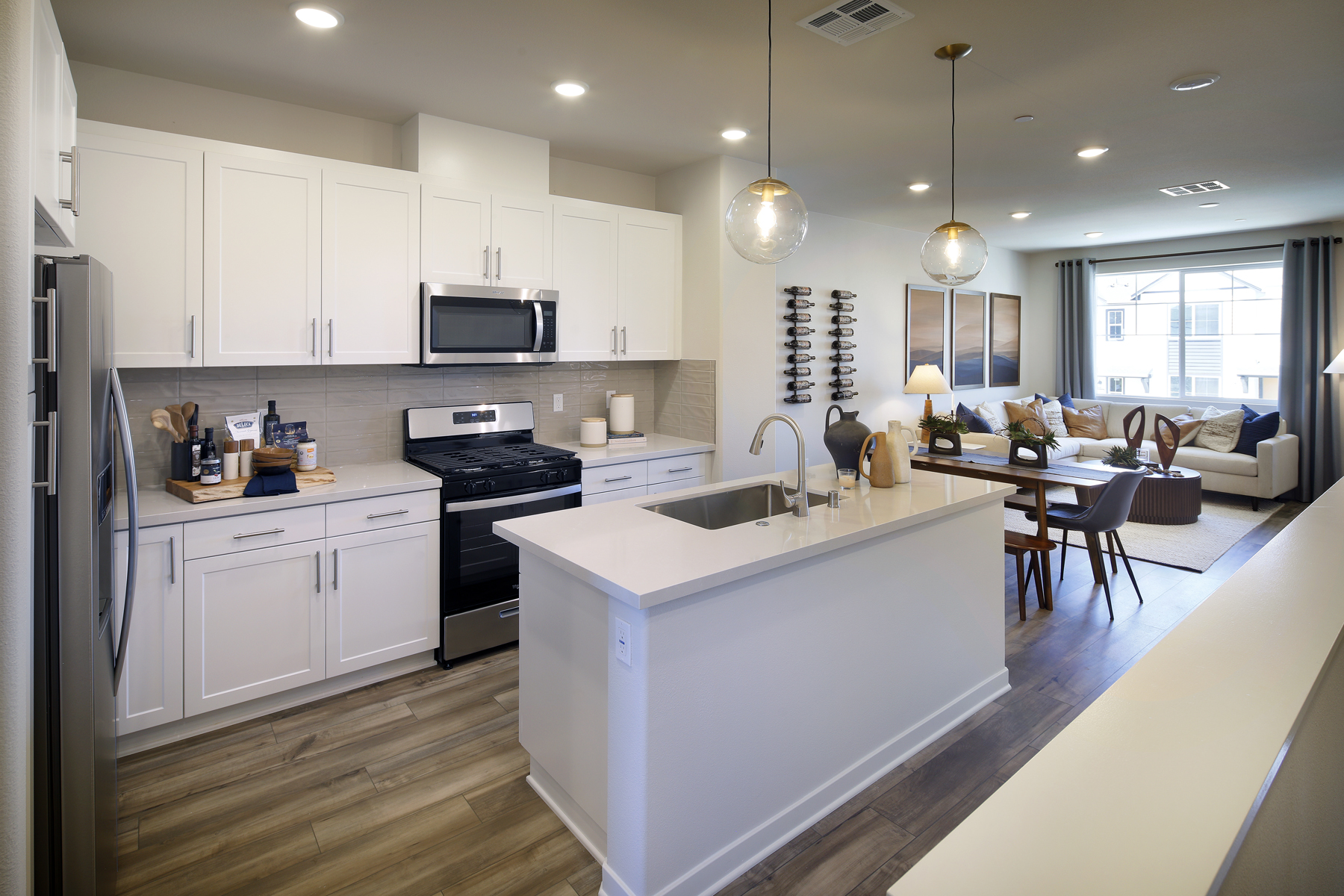 A kitchen with white cabinets.