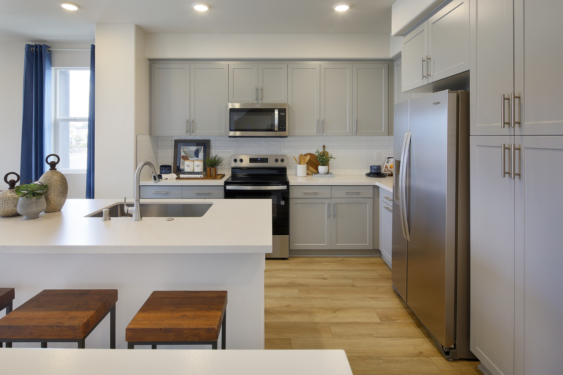A kitchen with white cabinets.