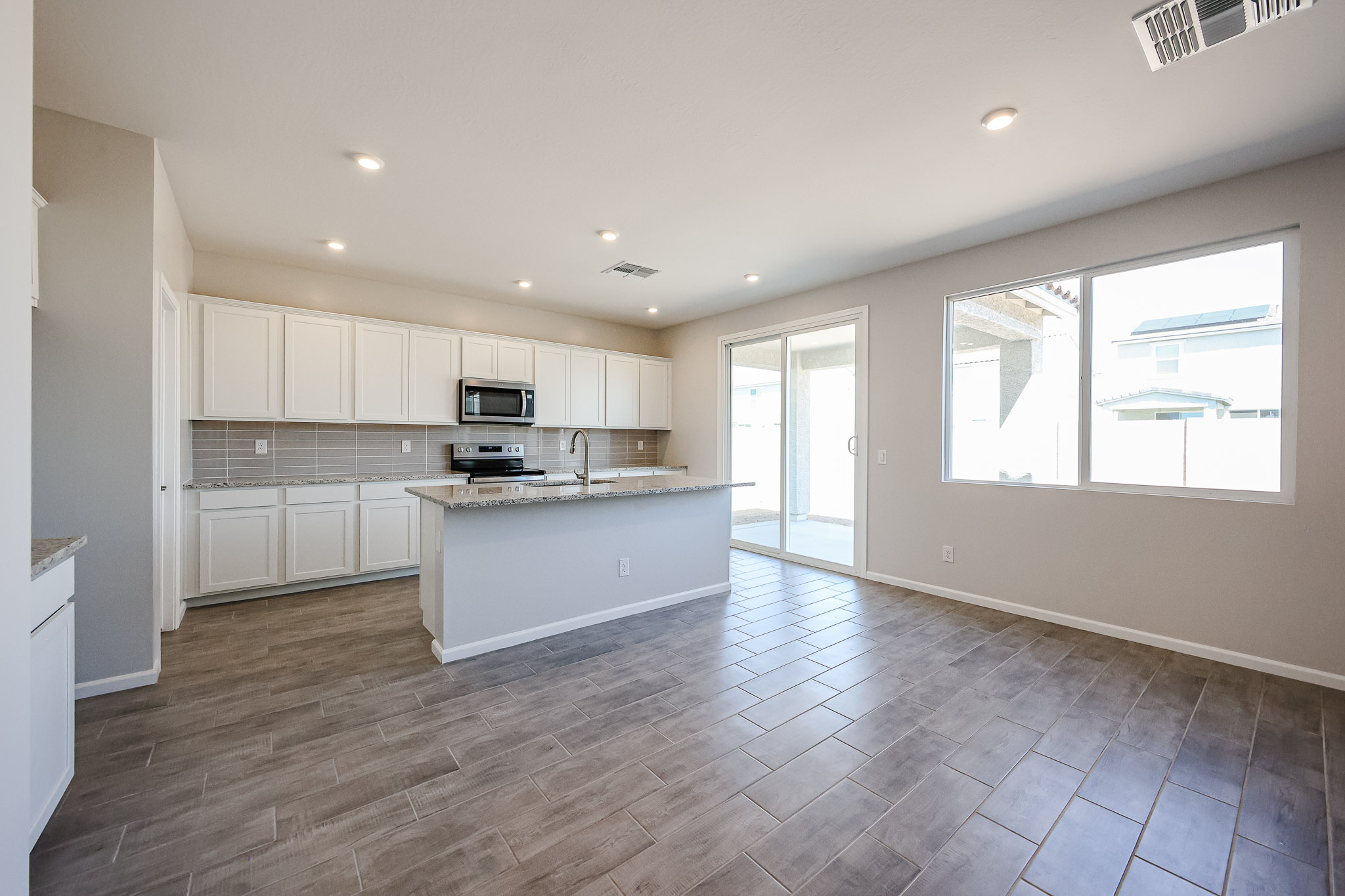 A kitchen with white cabinets.