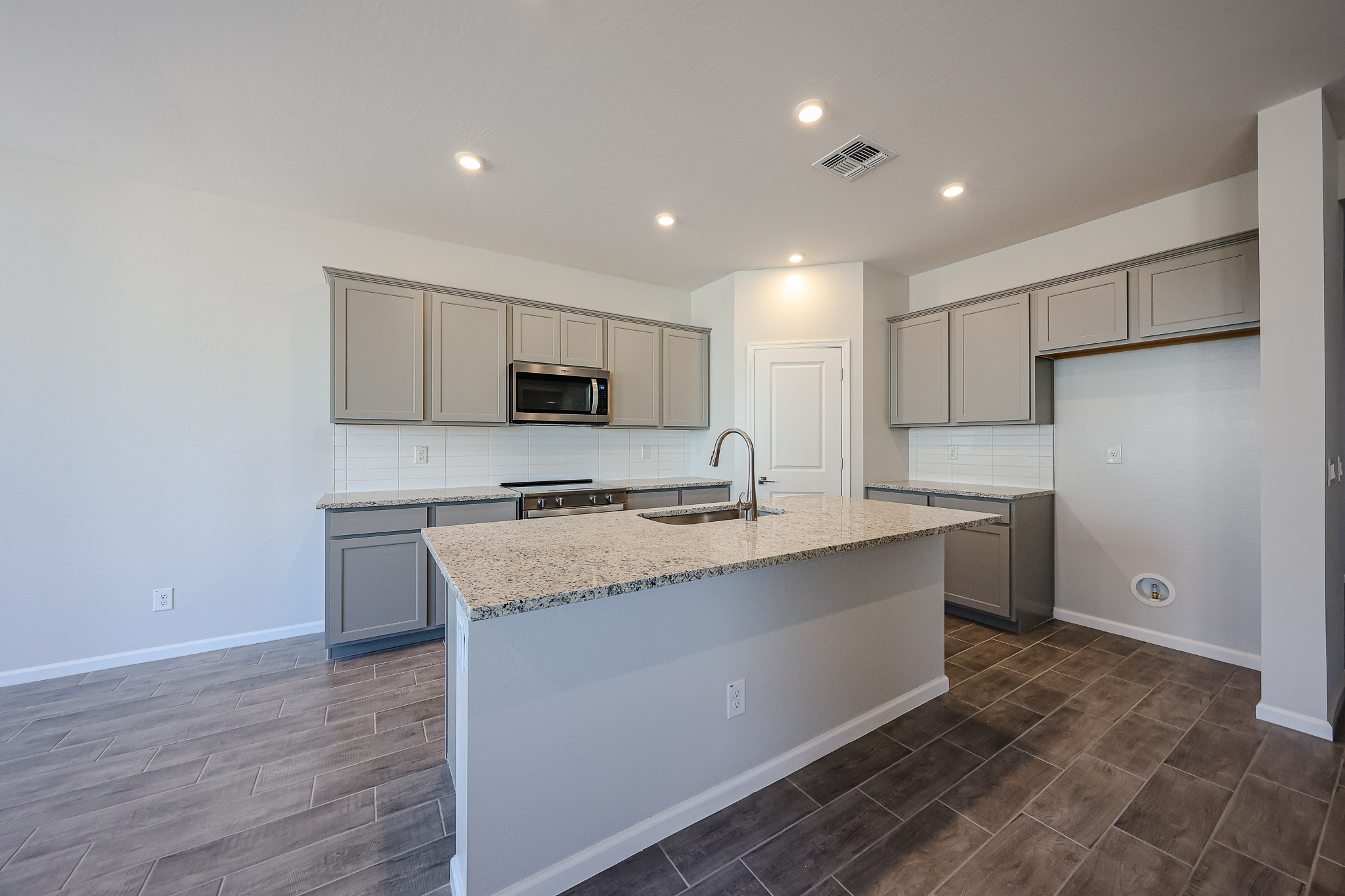 A kitchen with white cabinets.