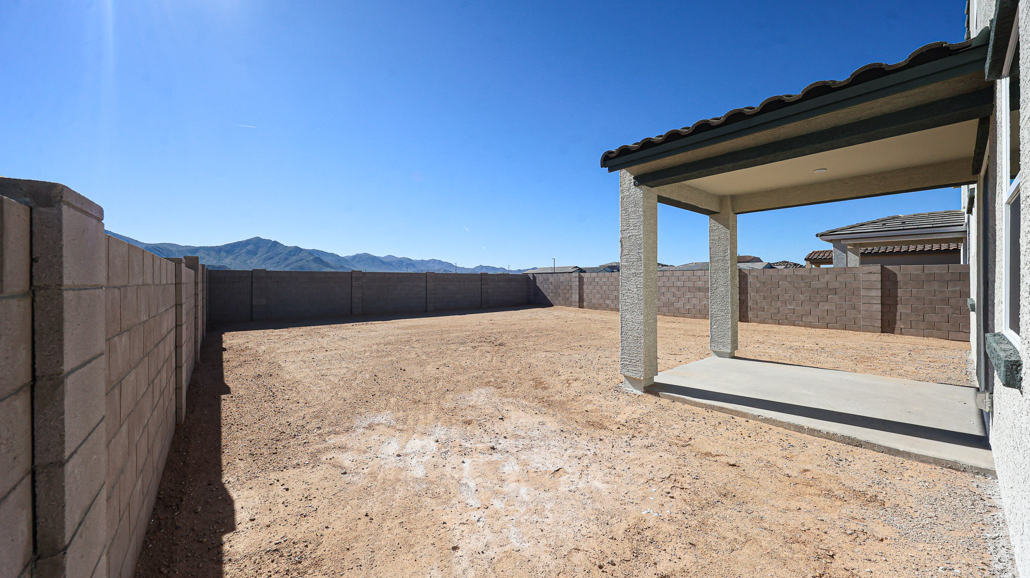 A dirt road between buildings.