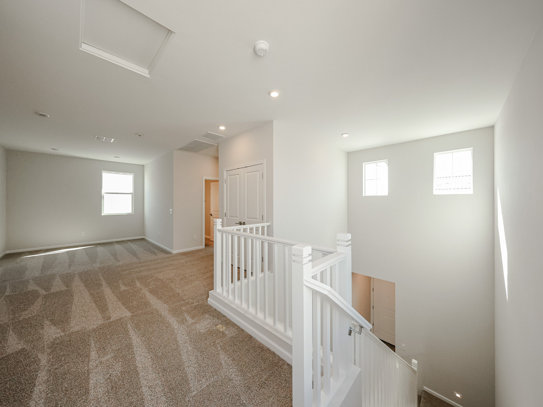 A hallway with white railings.