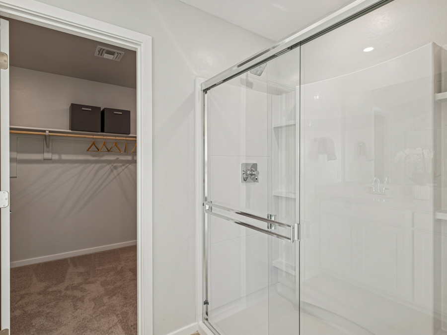 A shower with glass doors.