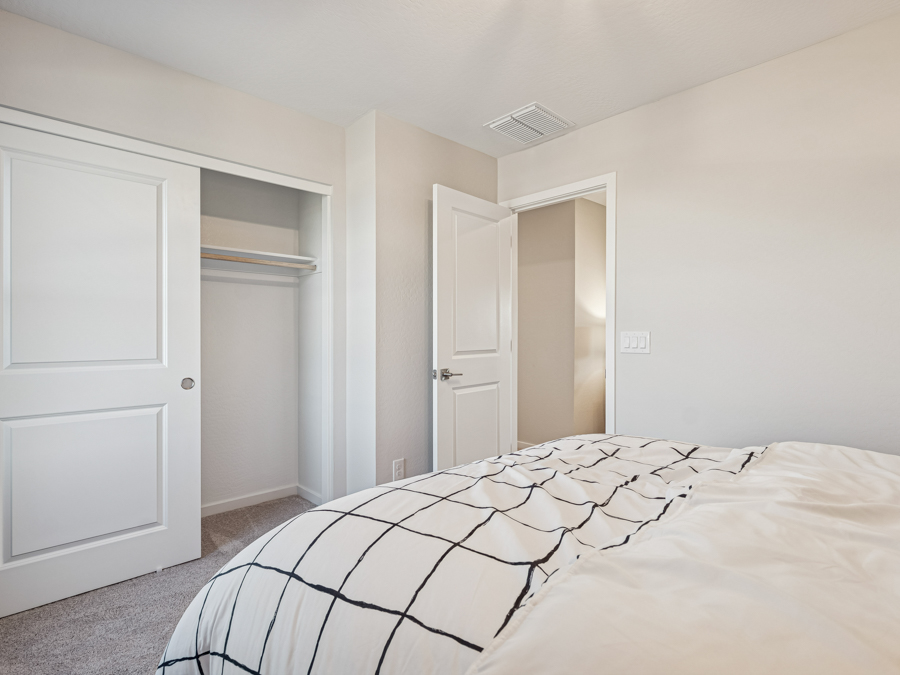 A bedroom with white walls.
