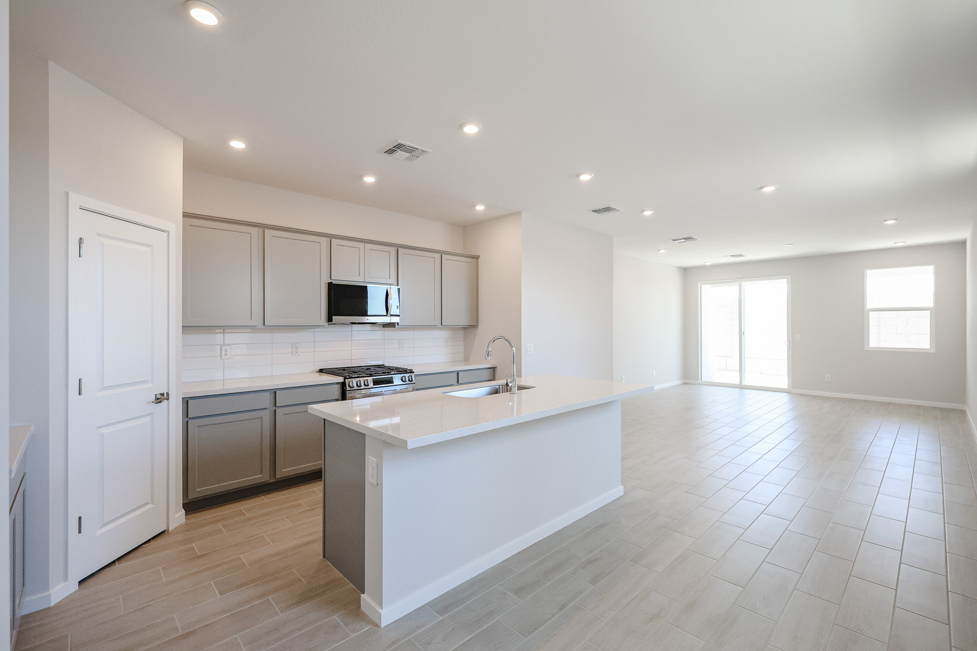 A kitchen with white cabinets.