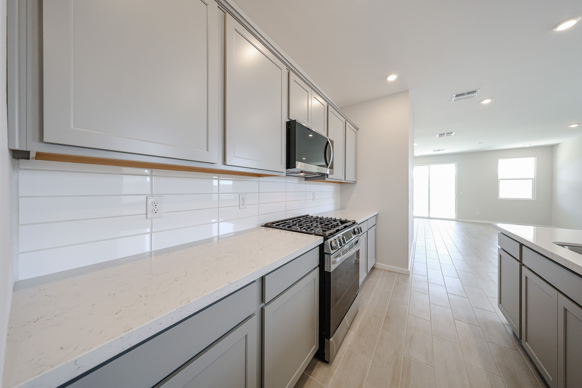 A kitchen with white cabinets.