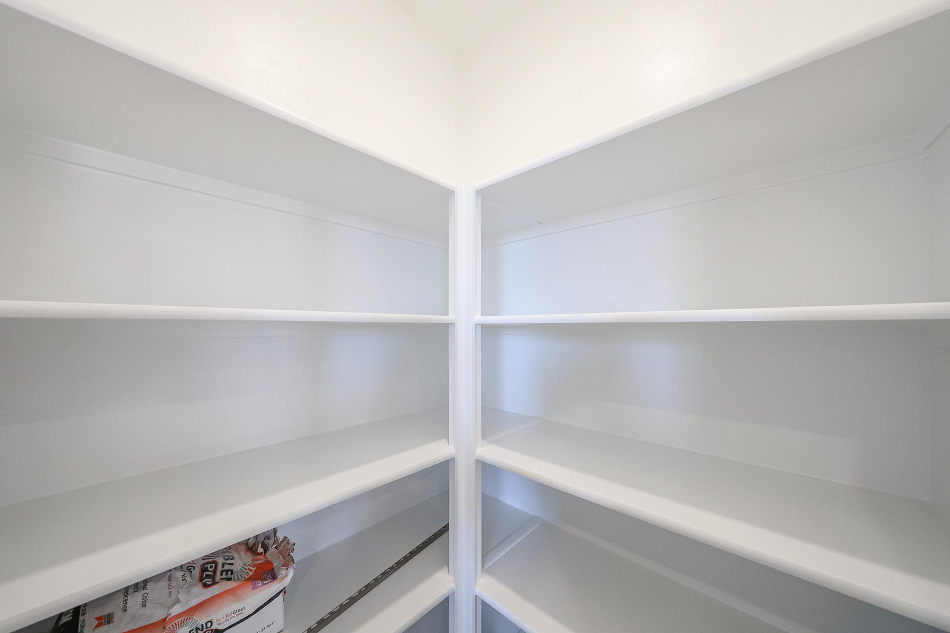 A white shelf with a book.