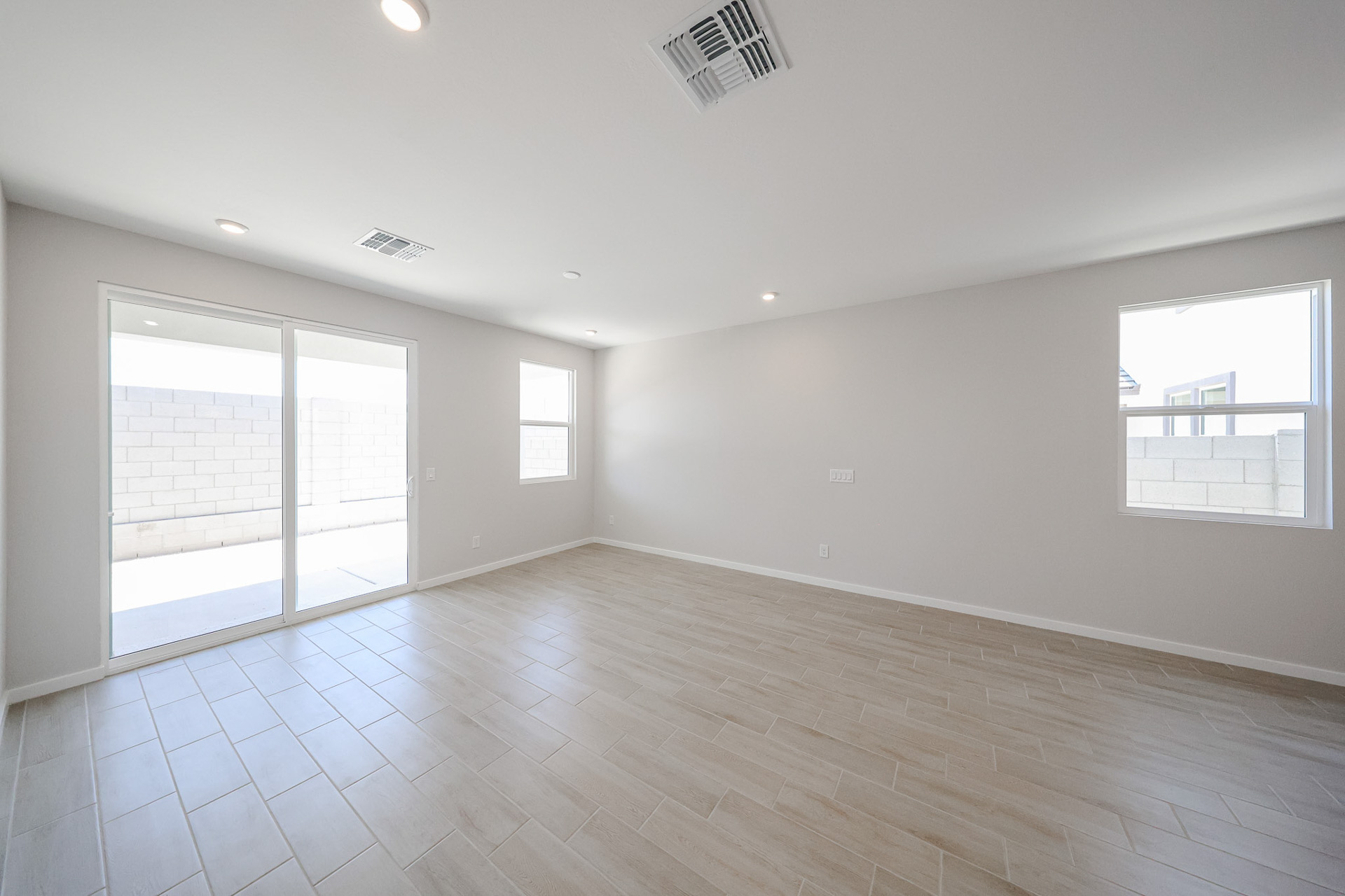 A room with a wood floor and windows.