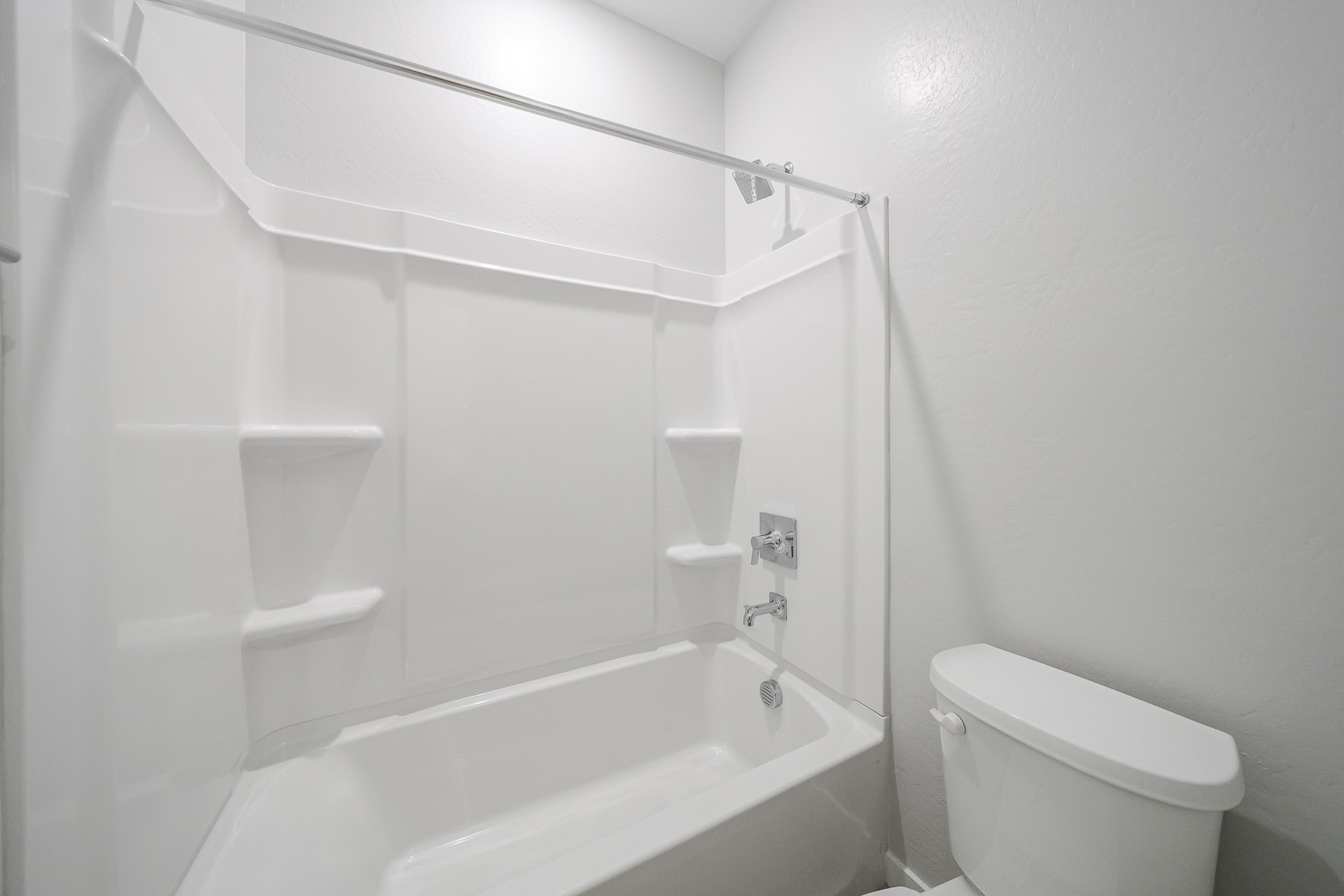 A bathroom with a bathtub and toilet.