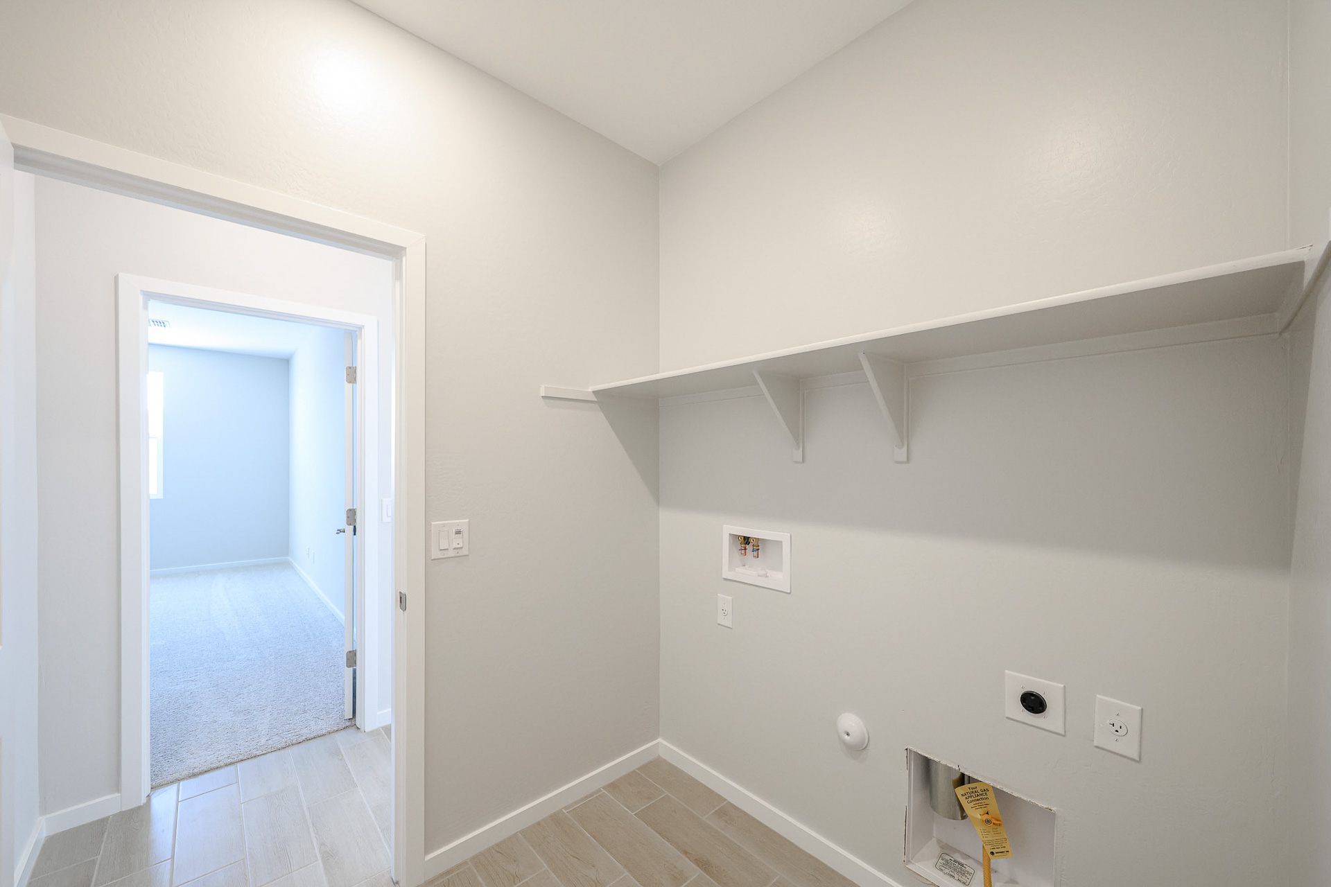 A hallway with a door and a window.