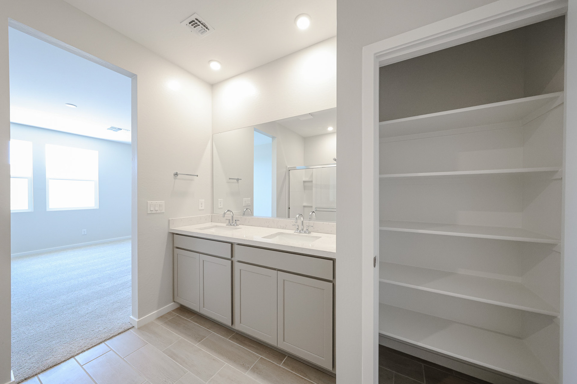 A bathroom with white cabinets.