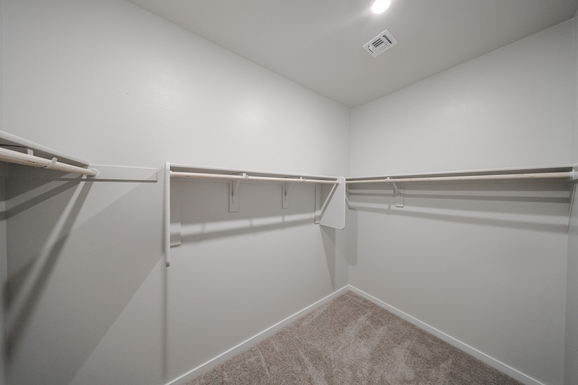 A white room with a metal railing.