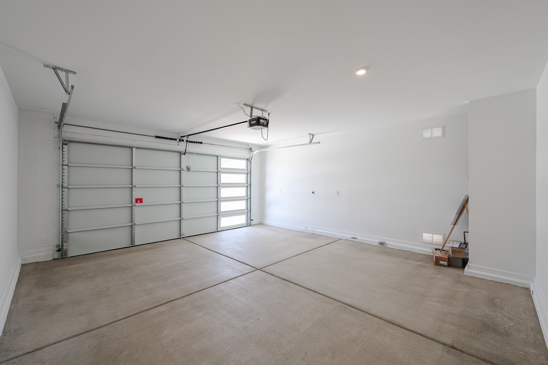 A room with a white wall and a metal door.