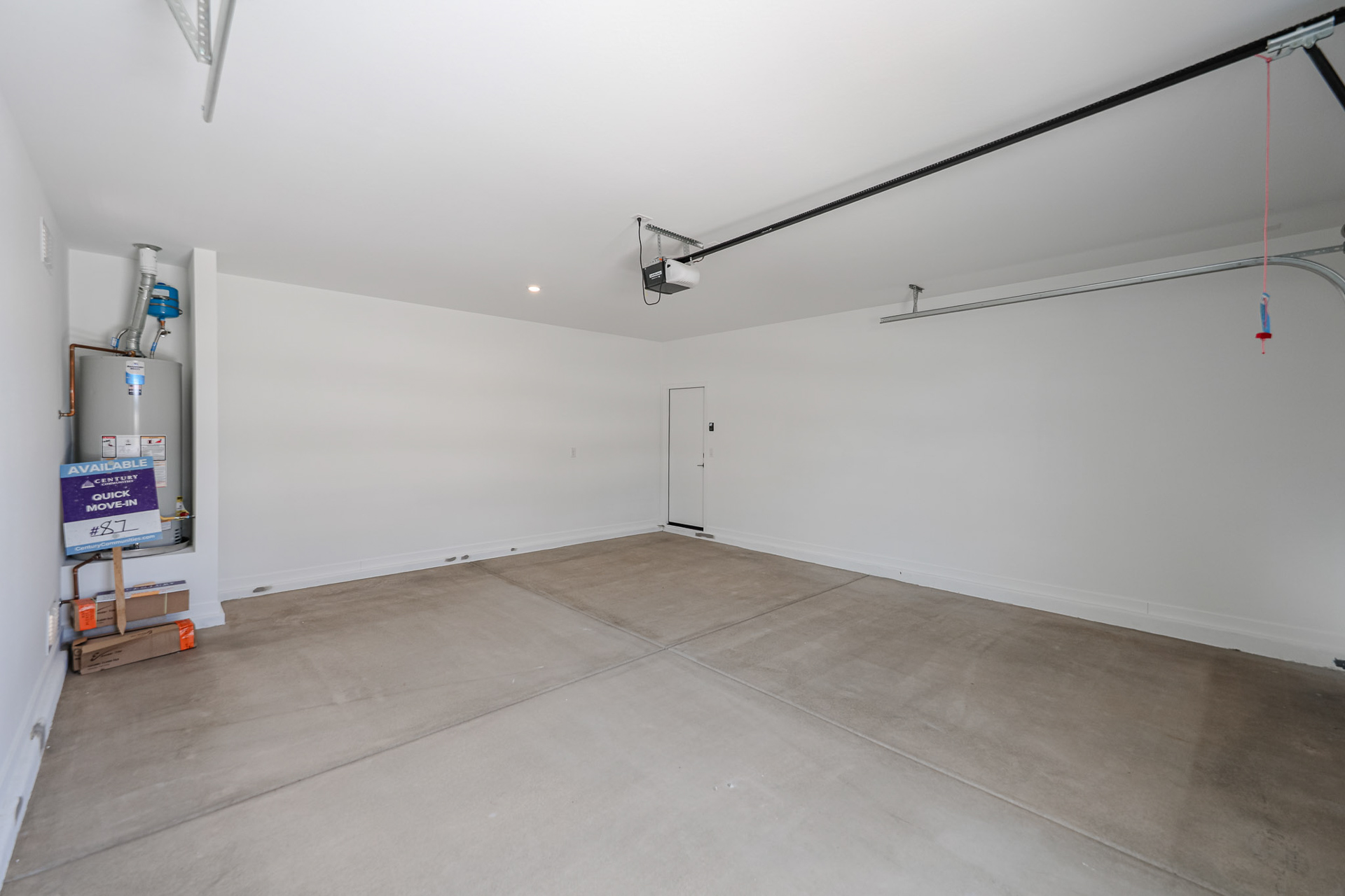 A room with a tv and a white wall.