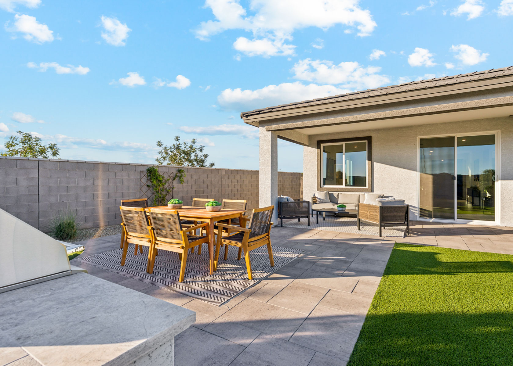 A patio with a table and chairs.