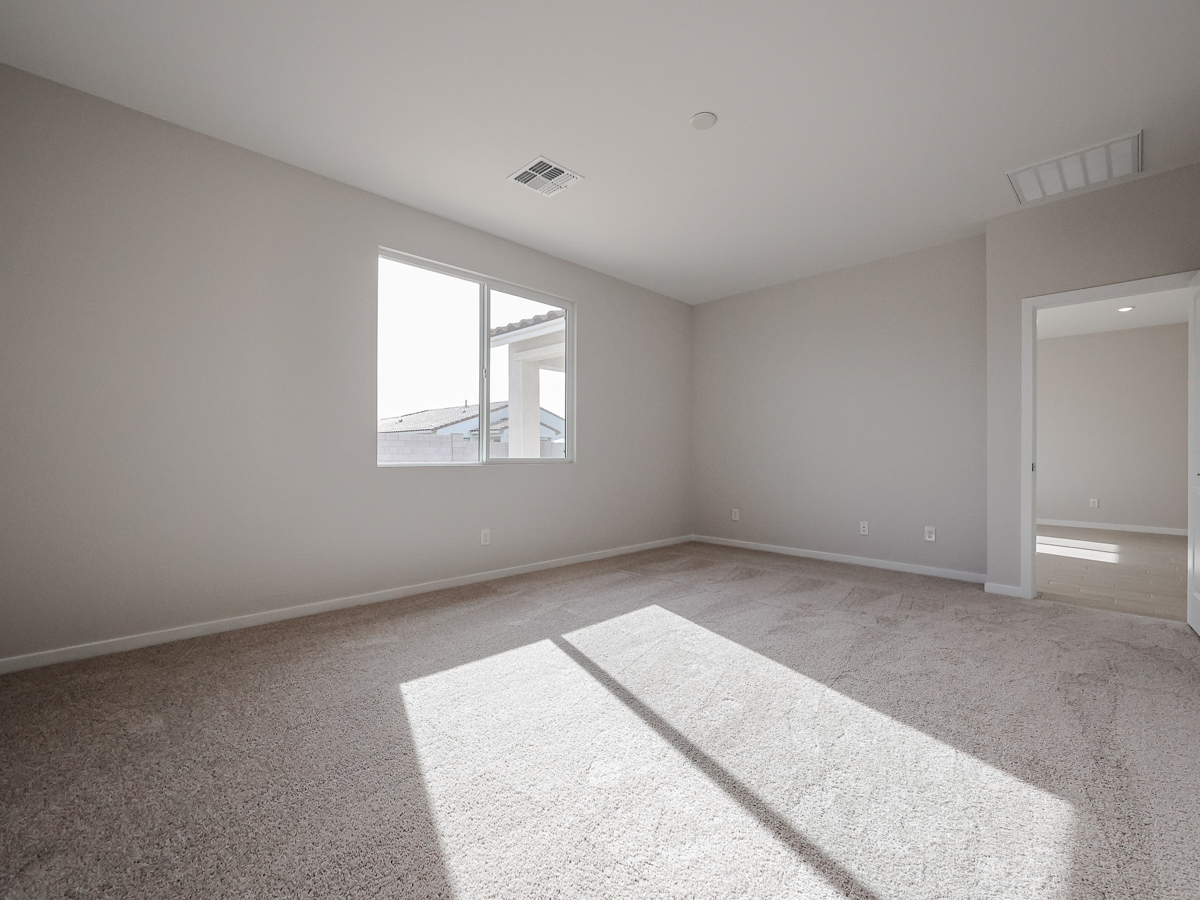 A room with a rug and a window.