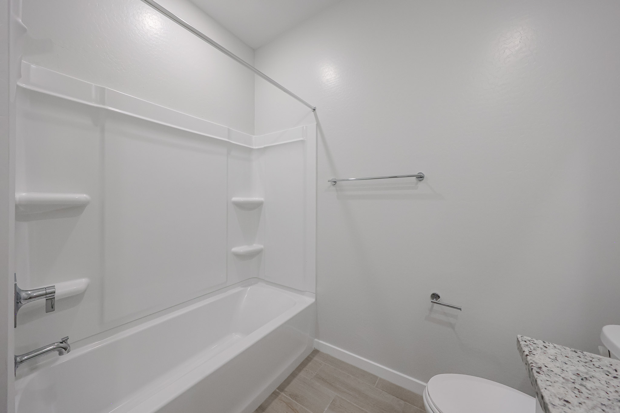 A bathroom with a bathtub and toilet.