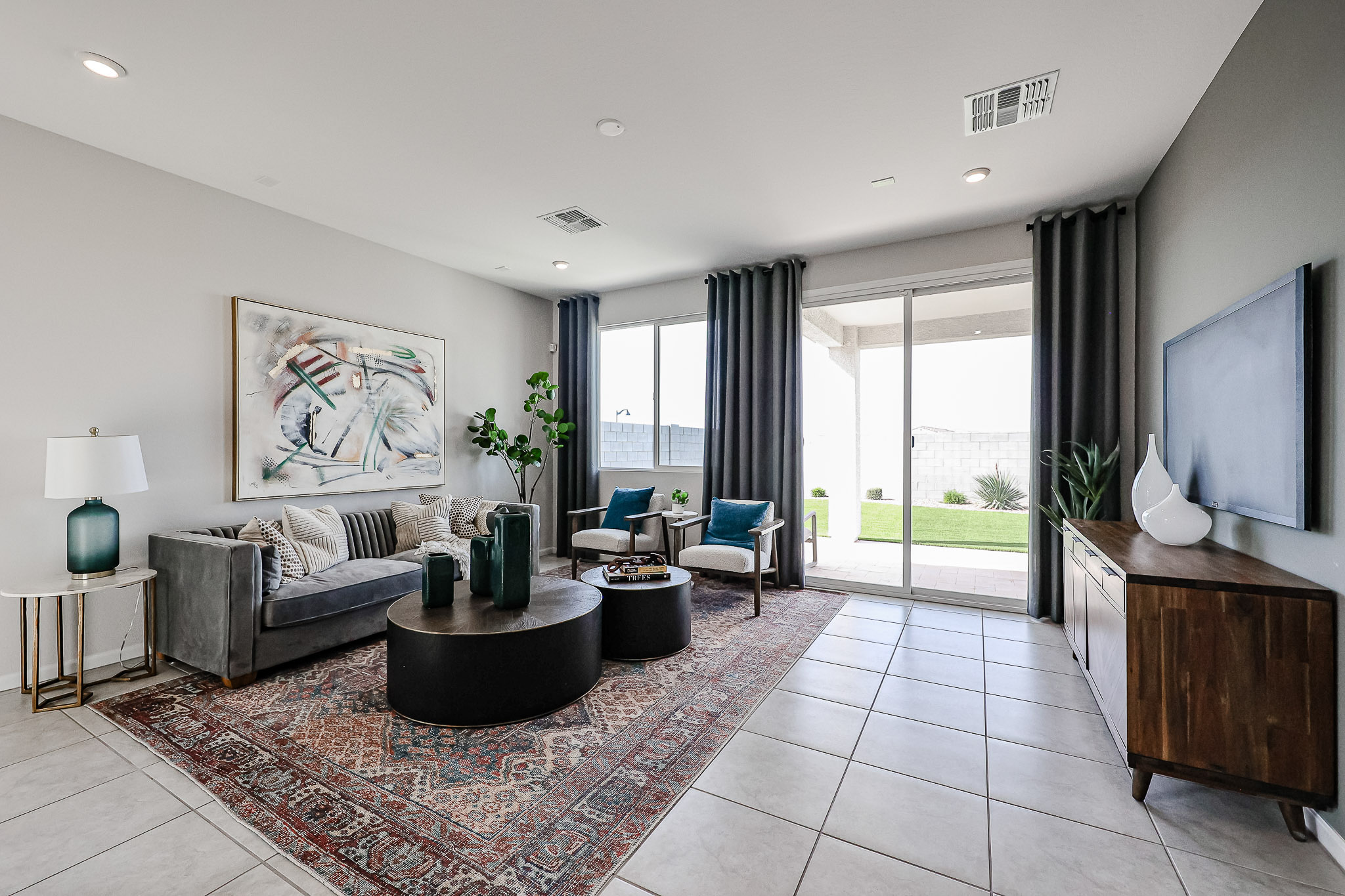 A living room with a large rug.