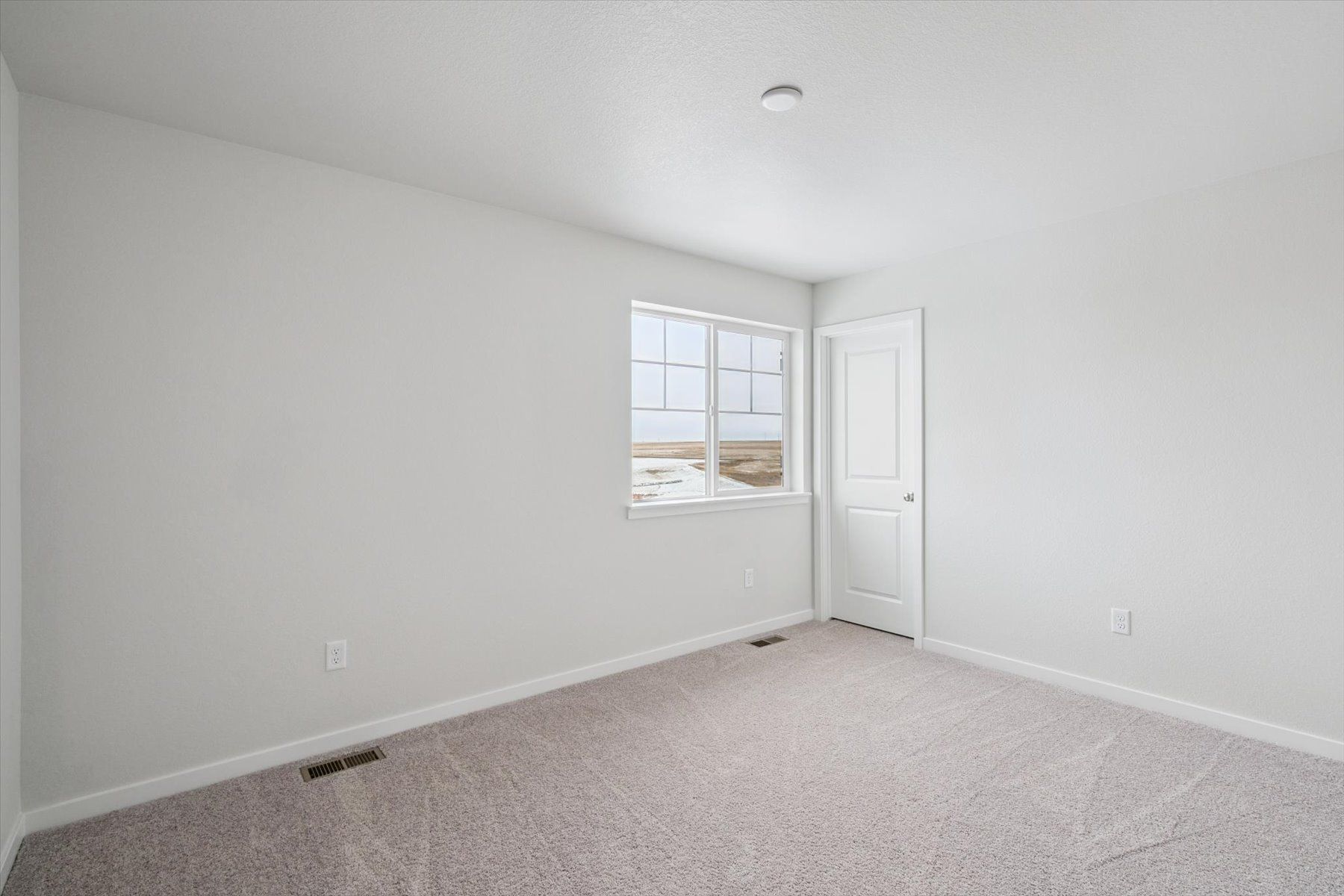 A room with a window and a door.