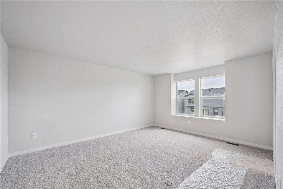 A room with a carpet and a rug.