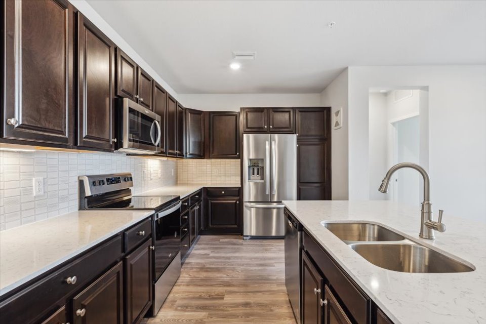 A kitchen with black cabinets.