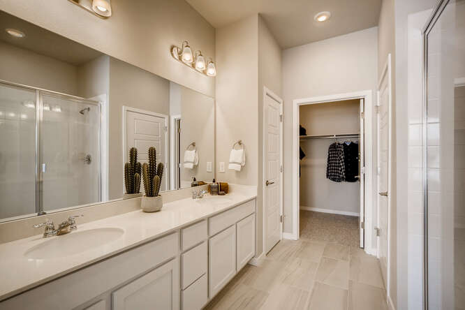 A bathroom with a large mirror.